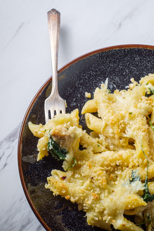 Creamy baked chicken alfredo with penne pasta topped with parmesan and mozzarella cheeses and panko breadcrumbsの写真素材