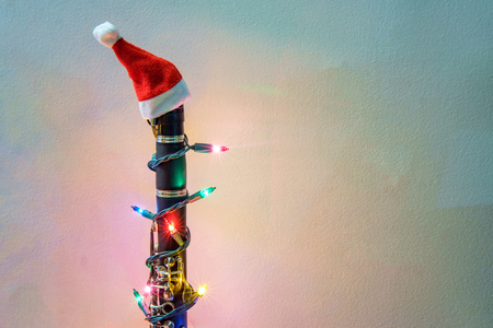 Seasonal holiday musical instrument clarinet with Christmas santa hat and lightsの写真素材