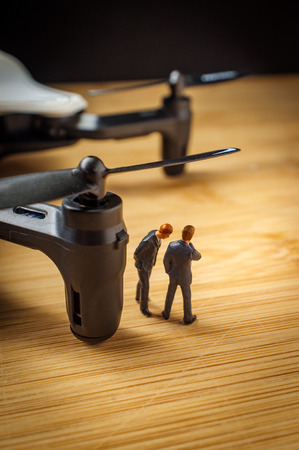 Closeup macro miniature businessmen figurines with drone quadcopterの写真素材