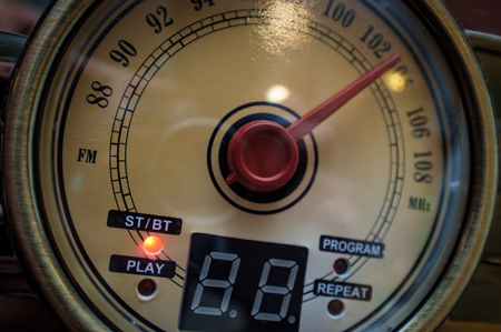 Closeup macro vintage radio round tuning dial with red needle