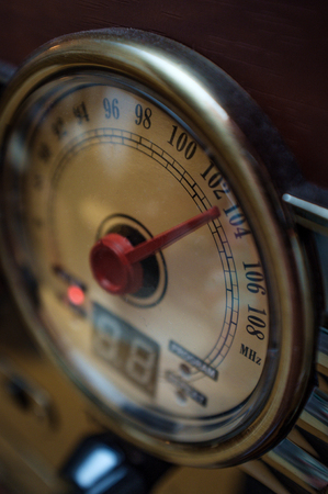 Closeup macro vintage radio round tuning dial with red needleの写真素材