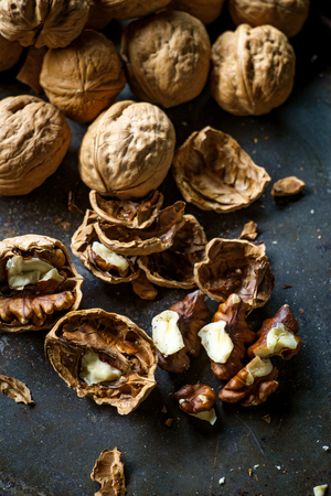 Cracked walnuts and shells with dark moody rustic atmosphereの写真素材