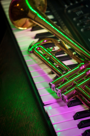 Old and worn Jazz trumpet and piano keyboard musical show and performanceの写真素材