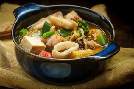 Korean seafood stew also called Haemul Jeongol with tofu tilapia octopus and calamariの写真素材