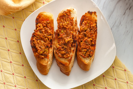 Traditional Portuguese olive bruschetta petiscos appetizer on crusty bread