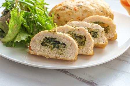 Herbed Mediterranean stuffed chicken breast with side saladの写真素材