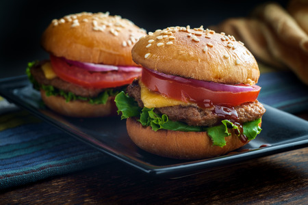 Rustic moody cheeseburger sliders with sesame seed buns