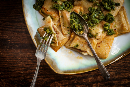 Lightly fried Italian meat raviolis with fresh pesto sauceの写真素材