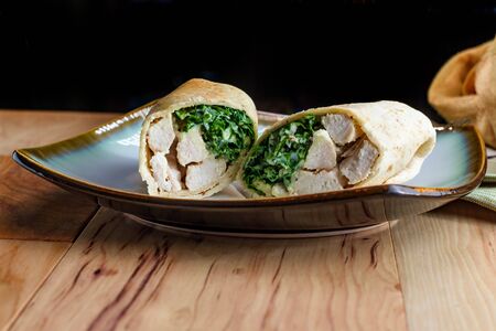 Chicken Caesar salad wrap sandwich with kale and parmesan cheeseの写真素材