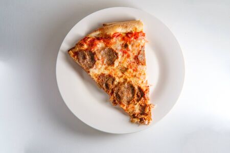 New York style slice of pizza with sliced meatball toppingの写真素材