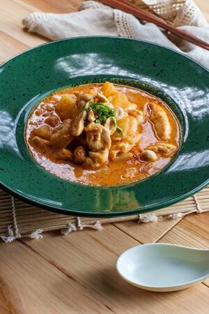Thai food spicy coconut milk massaman curry soup with chicken and potatoesの写真素材