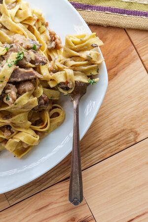 Fettuccine stroganoff with steak mushrooms and crumbled sausageの写真素材