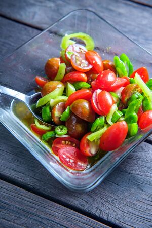 Grape tomato mixed hot pepper salad with olive oil dressingの写真素材