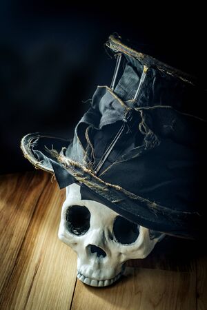 Scary jawless Halloween skull wearing old distressed top hatの写真素材