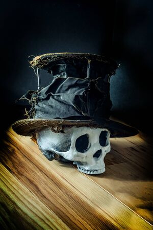 Scary jawless Halloween skull wearing old distressed top hatの写真素材