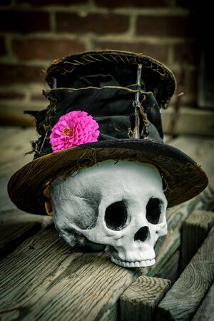 Scary jawless Halloween skull wearing old distressed top hatの写真素材