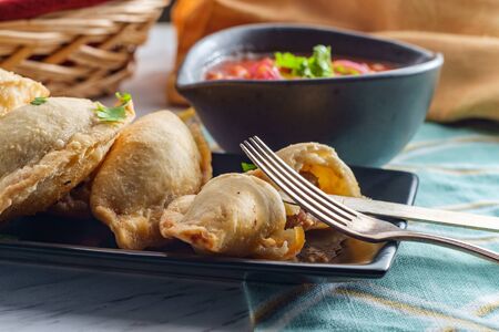 Mexican beef empanadas with tortilla chips and corn salsaの写真素材