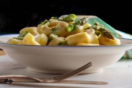 Italian butter and parmesan cheese tortellini alfredo with asparagusの写真素材