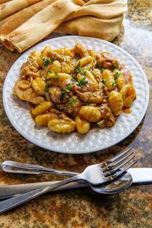 Hungarian chicken paprikash with gnocchi potato dumplings and basil