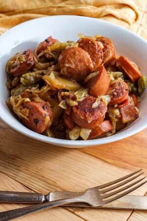 Polish kielbasa potatoes onions and peppers hash with cole slawの写真素材