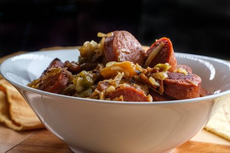Polish kielbasa potatoes onions and peppers hash with cole slawの写真素材