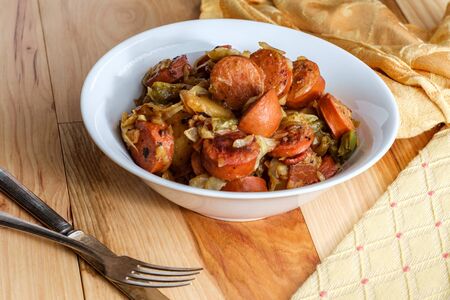 Polish kielbasa potatoes onions and peppers hash with cole slawの写真素材