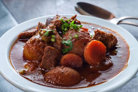 Authentic Irish beef beer stew with new potatoes carrots mushrooms and green peas