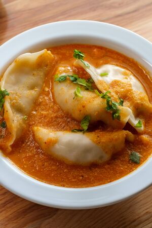 Nepalese Momo jhol achar dumpling soup in spicy tomato chutneyの写真素材