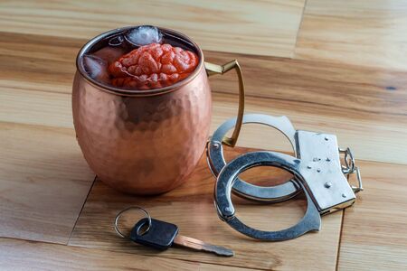 Human brain in copper Moscow mule cocktail mug soaking with car keys and handcuffs for alcoholism...