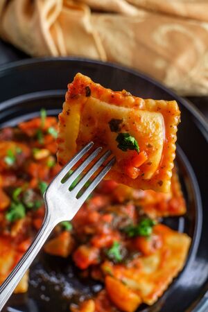 Italian ravioli a la florentine with spinach marinara sauceの写真素材