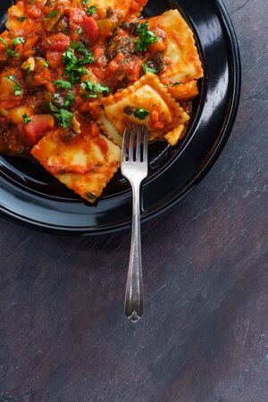 Italian ravioli a la florentine with spinach marinara sauceの写真素材