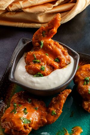 Hot and spicy buffalo wings with blue cheese dipping sauceの写真素材