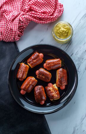 Mini pretzel hot dog pigs in a blanket with dijon mustard for dippingの写真素材