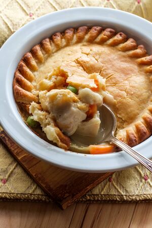 Crispy flaky baked chicken pot pie in white bowlの写真素材