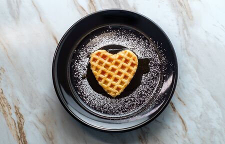 Heart shaped breakfast waffle for Valentine's day romance conceptの写真素材