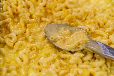 Delicious macaroni and cheddar cheese pasta serving buffet platter