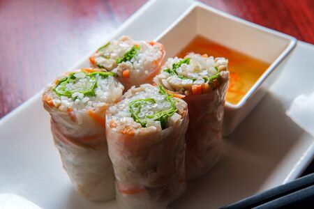 Fresh sliced vietnamese vegetable spring rolls with chicken and sweet vinegar dipping sauce