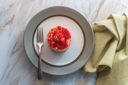 Personal size round red velvet cake with cream cheese icing fillingの写真素材