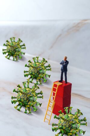 Smart businessman uses ladder to climb away and escape the deadly coronavirusの写真素材