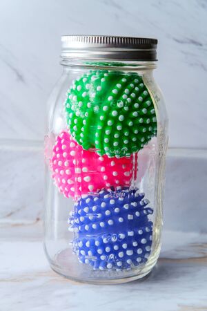 Quarantined deadly coronavirus cells trapped in a glass mason jar stopping the spread metaphor