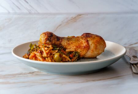 Spanish fideo con pollo chicken legs with vermicelli green olives and kale