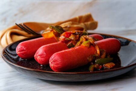 Hot spicy sausage with sliced peppers and onionsの写真素材