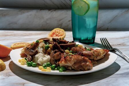 Baked chicken thighs with mashed potatoes and gravyの写真素材