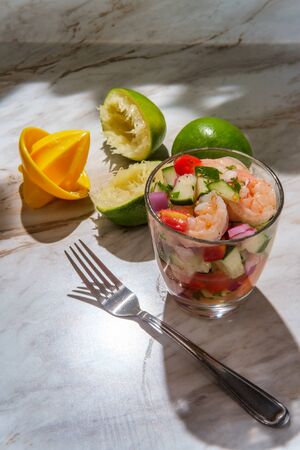 Chilled Peruvian ceviche with shrimp on marble kitchen tableの写真素材