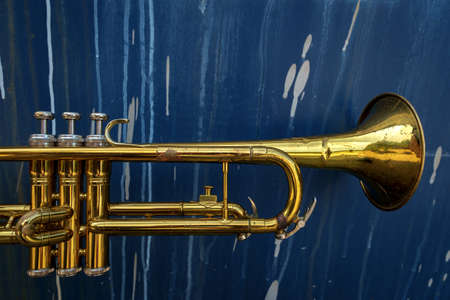 Old rusty Jazz instrument trumpet against distressed grunge backgroundの写真素材