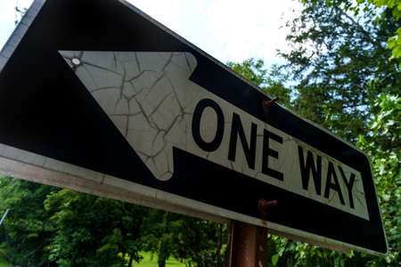 Closeup one way arrow sign indicating the direction of traffic