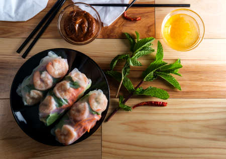 Fresh sliced vietnamese shrimp and vegetable spring rolls with peanut satay dipping and duck sauce