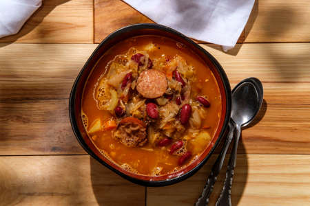 Traditional Polish sauerkraut kielbasa sausage and bean soup