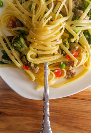 The works loaded fettuccine alfredo with sausage and vegetablesの写真素材
