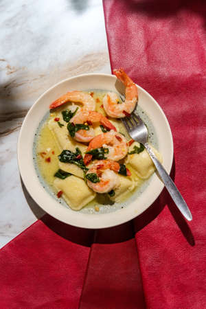 Tuscan creamy shrimp and cheese ravioli with spinachの写真素材